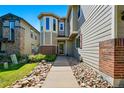 Attractive townhome featuring brick accents, large windows, and inviting entryway at 12925 Grant Cir # A, Thornton, CO 80241
