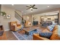 Inviting living room featuring hardwood floors, a ceiling fan, and an open layout leading to the dining area and kitchen at 7665 Grady Cir, Castle Rock, CO 80108