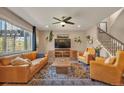 Bright living room with large windows, stylish furnishings, and a cozy atmosphere for relaxation at 7665 Grady Cir, Castle Rock, CO 80108