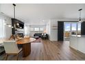 Spacious living room with modern fireplace, hardwood floors, and access to the outdoor patio at 14268 Hop Clover Trl, Parker, CO 80134
