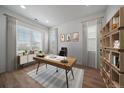 Bright office with modern desk, stylish bookcase, and plenty of natural light at 14268 Hop Clover Trl, Parker, CO 80134