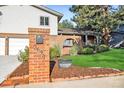 Brick mailbox post at the entrance of a home with a landscaped yard at 2695 S Ammons Way, Lakewood, CO 80227