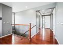 Inviting foyer features hardwood floors, neutral paint, and staircase at 7426 E 148Th Pl, Thornton, CO 80602
