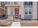 Exterior features a stylish red door, well-maintained landscaping, and a covered front porch at 3560 Corsica Way, Castle Rock, CO 80109