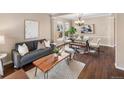 Cozy living room with hardwood floors, neutral walls, and stylish modern furniture at 10606 Cottoneaster Way, Parker, CO 80134