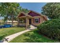 Updated brick home with a welcoming front porch and landscaping at 3560 N Columbine St, Denver, CO 80205