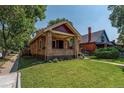 Charming brick home with a covered porch and lush lawn at 3560 N Columbine St, Denver, CO 80205