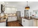 Modern kitchen featuring stainless steel appliances, and dark countertops with white cabinetry at 94 Spring Ln, Boulder, CO 80302