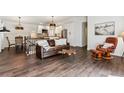 Inviting living room with hardwood floors and an open layout to the kitchen and dining area at 94 Spring Ln, Boulder, CO 80302