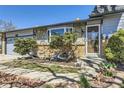 Well-kept home with stone and siding, landscaped garden beds, and welcoming entrance at 11123 Clermont Dr, Thornton, CO 80233