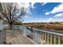 Enjoy the view from this home's spacious wooden deck with white railing at 5204 Shetland Ct, Highlands Ranch, CO 80130