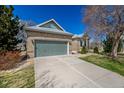 Charming brick home with a two-car garage and manicured lawn under a clear blue sky at 5204 Shetland Ct, Highlands Ranch, CO 80130