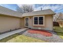 Home entrance featuring tidy landscaping, a security door, and adjacent window at 3969 S Fundy Cir, Aurora, CO 80013