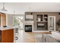 Open concept living area with fireplace, built-in shelving, and seamless flow from kitchen to living space at 8122 E 6Th Pl, Denver, CO 80230