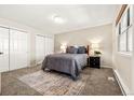 Bedroom with neutral colors, closet doors and plush carpet at 6664 S Webster St, Littleton, CO 80123