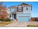 Beautiful two-story home featuring blue siding, a two-car garage, and a well-kept front yard at 5556 Lewiston Ct, Denver, CO 80239