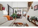 Comfortable living area with fireplace, large windows, and staircase to upper level at 5556 Lewiston Ct, Denver, CO 80239