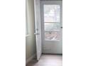 Open white door leads to outdoor space with light hardwood flooring at 3225 S Garrison St # 19, Lakewood, CO 80227
