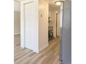 Kitchen view featuring stainless steel appliances, light wood look floors, and a storage closet at 3225 S Garrison St # 19, Lakewood, CO 80227