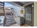Welcoming condo entrance with a secure door, staircase, and decorative touches at 7891 Allison Way # 201, Arvada, CO 80005