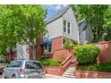 Stylish townhome boasts brick accents, a small garden area, and lush green trees at 1030 Jersey St # 1, Denver, CO 80220