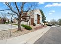 This two-story condo building features inviting stairs, a balcony, and landscaping for a warm welcome at 9677 W Chatfield Ave # E, Littleton, CO 80128