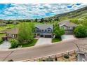 An aerial view showcases this two-story home in a desirable neighborhood with mountain views at 19105 Eagle Ridge Dr, Golden, CO 80401