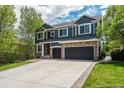 Beautiful home featuring a spacious driveway, lush greenery, and an attached three-car garage at 19105 Eagle Ridge Dr, Golden, CO 80401