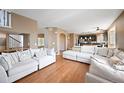 Open concept living area featuring hardwood floors and ample natural light at 1386 Avgare Way, Erie, CO 80516