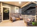 Inviting front porch with comfortable seating and stylish decor, great for relaxing outdoors at 56 Magnolia Ct, Erie, CO 80516