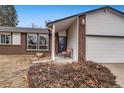 Brick home's front entrance with covered porch and landscaping at 3161 S Kalispell St, Aurora, CO 80013