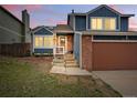 Charming two-story home boasts brick accents and an inviting facade with an attached two-car garage at 3593 S Gibralter Cir, Aurora, CO 80013