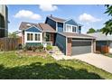 Charming two-story home with brick and blue siding, complemented by a well-manicured lawn and a two-car garage at 3593 S Gibralter Cir, Aurora, CO 80013