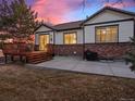 Spacious backyard featuring a wooden deck, concrete patio, and a well-kept lawn ideal for entertaining at 8099 Sabino Ln, Castle Rock, CO 80108