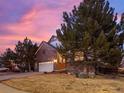 Beautiful brick home with a manicured front yard and mature trees, providing great curb appeal at 8099 Sabino Ln, Castle Rock, CO 80108