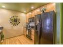 Kitchen with black appliances and granite countertops, offering modern convenience and style at 275 S Harrison St # 409, Denver, CO 80209