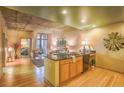 A full kitchen with stainless steel appliances, concrete ceilings, and hardwood floors at 275 S Harrison St # 409, Denver, CO 80209