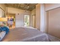 Well-lit primary bedroom with plush carpeting, closet, and access to a full bathroom at 275 S Harrison St # 409, Denver, CO 80209
