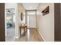 Bright entryway with hardwood floors, coat rack, and views of the bedroom at 15524 E 115Th Ave, Commerce City, CO 80022