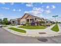 Corner lot home with attractive landscaping, sidewalks, and street sign at 15524 E 115Th Ave, Commerce City, CO 80022