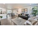 Bright living room with hardwood floors, stylish furniture, and an open concept design at 1926 S Yates St, Denver, CO 80219