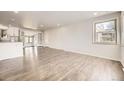 Bright living room featuring hardwood floors and a large window with lots of natural light at 1926 S Yates St, Denver, CO 80219