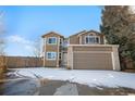 Traditional two-story home boasts updated windows, fresh paint, a two-car garage and a well-maintained front yard at 3948 S Halifax St, Aurora, CO 80013