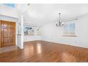 Bright living room with hardwood floors, fresh paint, and natural light pouring in from the updated energy efficient windows at 3948 S Halifax St, Aurora, CO 80013