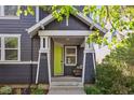 Inviting home entrance with a charming front porch featuring a lime green front door and cozy outdoor seating at 2857 Xanthia Ct, Denver, CO 80238