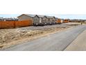 Attractive single-story home with a well-maintained yard and a wooden fence at 16378 Lamb Ave, Fort Lupton, CO 80621