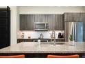Granite countertops and stainless steel appliances stand out in the contemporary kitchen at 3198 Blake St # 402, Denver, CO 80205