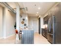 Modern kitchen with stainless steel appliances, central island, and decor at 3198 Blake St # 402, Denver, CO 80205