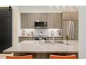 Modern kitchen with stainless steel appliances, granite countertops, and ample cabinet space at 3198 Blake St # 402, Denver, CO 80205