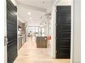 Open-concept living space with a kitchen featuring stainless steel appliances and a central island at 3198 Blake St # 402, Denver, CO 80205
